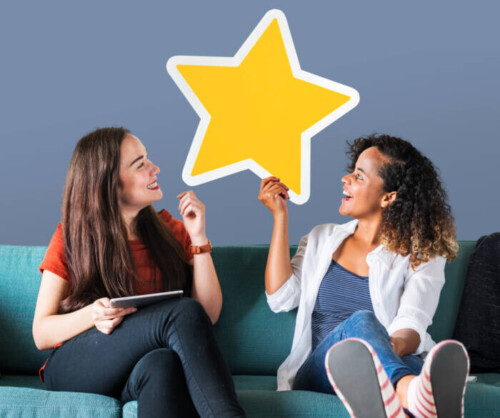 cheerful-women-holding-golden-star-icon-500x418 How Can I Build Up Online Reviews?